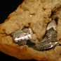 Colour image of orange rock with gay metallic rock showing through cracks