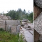Colour photograph of granite quarry with hammer to indicate scale of boulders