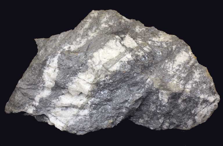 Image couleur d’une roche grise avec bandes blanches diagonales