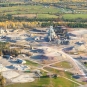 Colour aerial photograph of mine with towers, roads, buildings and piles of rock