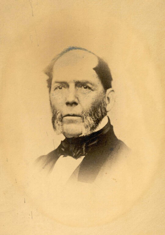 Black and white photograph of man in a suit with side whiskers